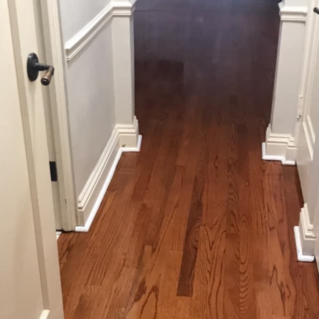 Refinished hardwood hallway in a warm brown stain