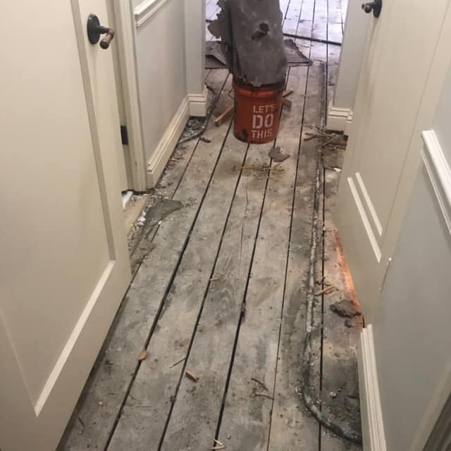 Original plank subfloor exposed during floor demolition