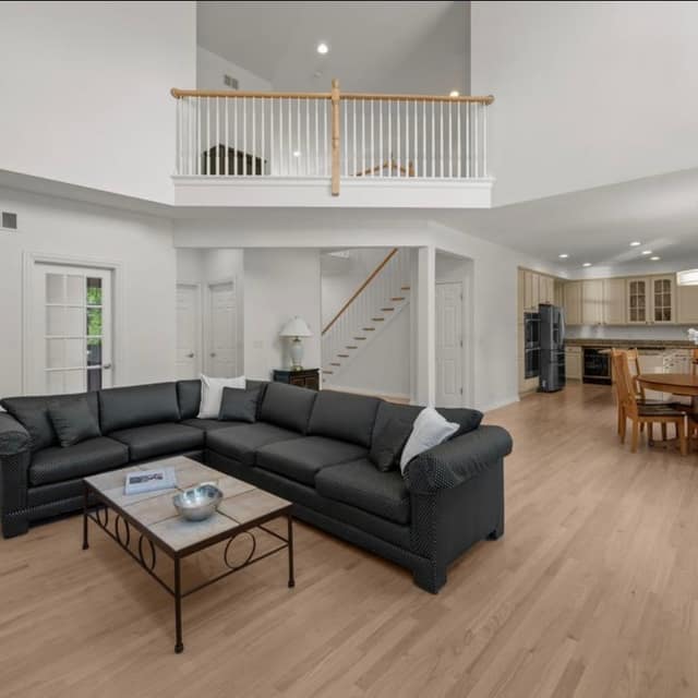 Great room with a pale finished hardwood floor