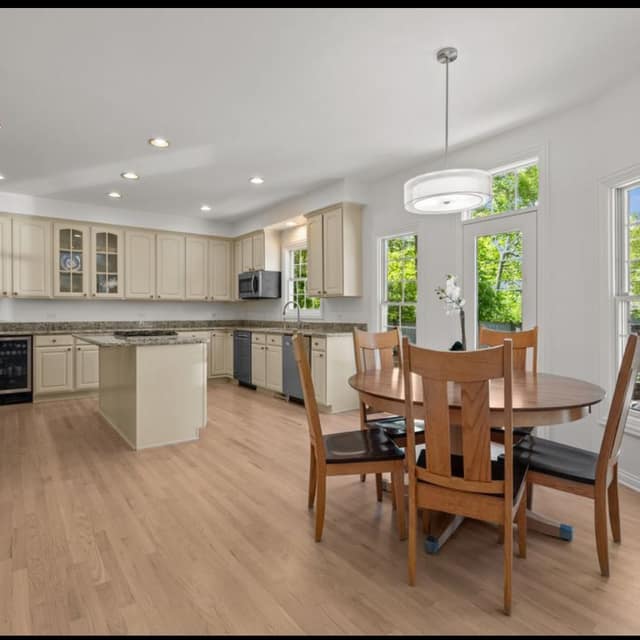 Kitchen and breakfast area with light wood-tone flooring