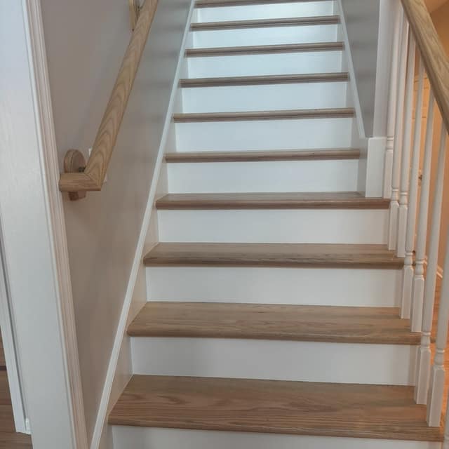 Refinished staircase with natural wood treads and white risers