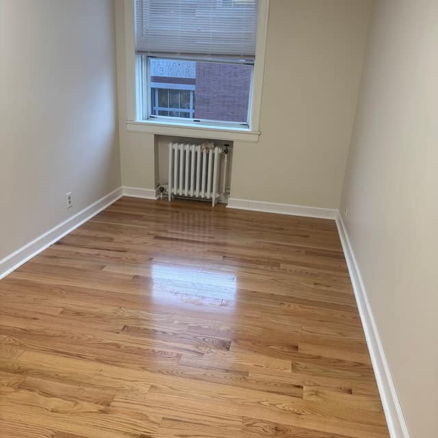 Refinished golden hardwood floor in an apartment room